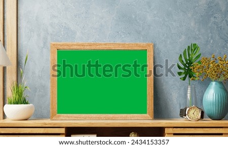Green screen Picture frame on old dark brick wall, modern interior wall and illuminated with spotlights

