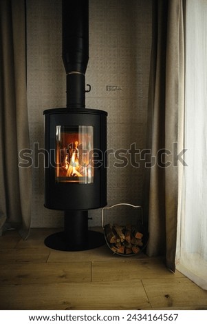Cozy fireplace interior in modern chalet Royalty-Free Stock Photo #2434164567