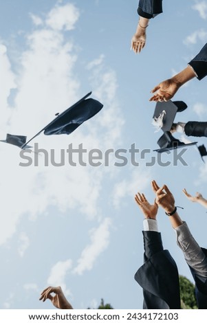 Graduates Celebrating Achievements and Creating Beautiful Memories in Park While Throwing Caps in the Air.