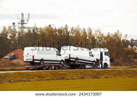 A tow truck helps a broken car on the highway. The car has been damaged by a collision and needs to be repaired Royalty-Free Stock Photo #2434173007