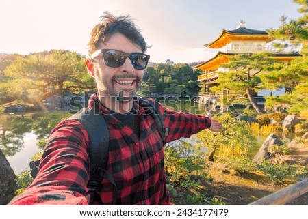Handsome young tourist enjoying summer holiday in Kyoto, Japan - Traveling life style concept with smiling man taking selfie on city street with japan Royalty-Free Stock Photo #2434177479
