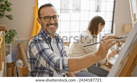Two smiling artists confidently drawing together in art studio, a happy painting class lesson brimming with creativity and learning Royalty-Free Stock Photo #2434187721