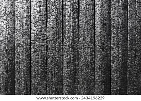 Burnt wooden board texture. Sho Sugi Ban Yakisugi is a traditional Japanese method of wood preservation Royalty-Free Stock Photo #2434196229