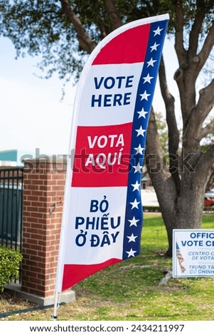 Vote flag banner and yard signs in multiple languages English, Spanish, Vietnamese, double-sided election decorations polling locations at elementary school, non-English-proficient groups in TX. USA