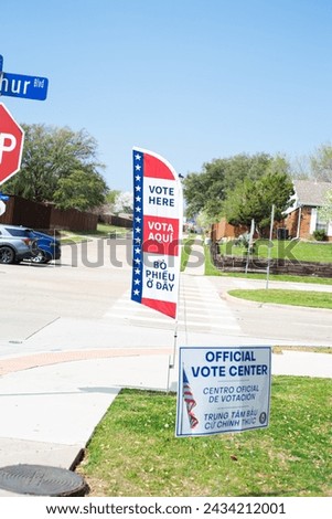 Street corner Stop and yard sign, vote banner flag show Official Vote Center in English, Spanish, Vietnamese welcome resident and non-English-proficient groups to voting location Dallas, Texas. USA