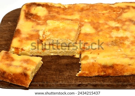 The picture shows a casserole made from cottage cheese and pumpkin. A piece has been cut from the casserole.