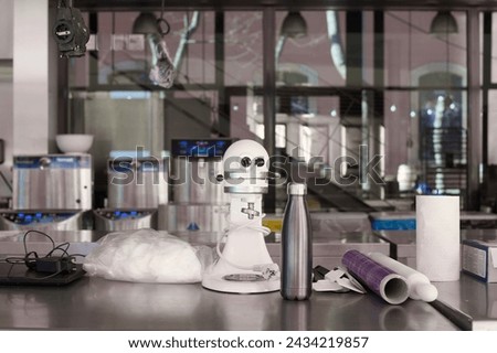 Image of a modern laboratory with a kitchen robot, scientific instruments and materials, ideal to represent innovation and technology in the science of new dessert preparation in the kitchen. Royalty-Free Stock Photo #2434219857