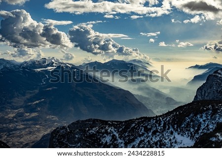 Snow covered Italian Dolomites at winter. Lake garda view in  Trentino-Alto Adige, Italy. Ski slopes and snow holidays in Andalo in the Italian Dolomites, ski resort in the Alps. Royalty-Free Stock Photo #2434228815