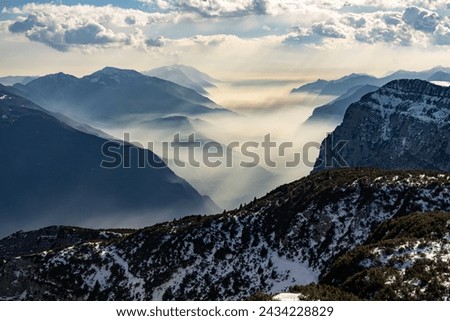 Snow covered Italian Dolomites at winter. Lake garda view in  Trentino-Alto Adige, Italy. Ski slopes and snow holidays in Andalo in the Italian Dolomites, ski resort in the Alps. Royalty-Free Stock Photo #2434228829