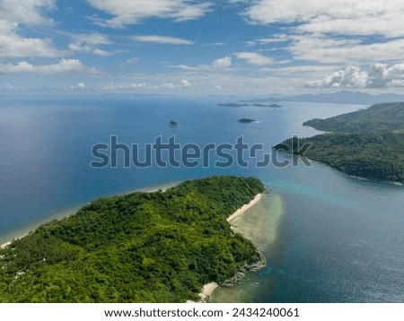 Tropical Islands with beaches. Blue sea under blue sky and clouds. El Nido. Palawan, Philippines.
