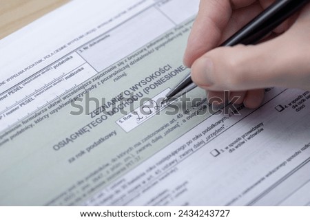 Fill out and submit a tax return to the tax office, PIT form close up, translation: example Polish tax form - declaration of income Royalty-Free Stock Photo #2434243727