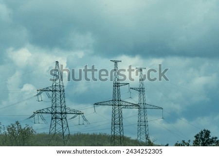 High voltage towers with sky background. Power line support with wires for electricity transmission. High voltage grid tower with wire cable at distribution station. Energy industry, energy saving Royalty-Free Stock Photo #2434252305