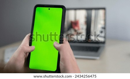 martphone with chroma key green screen at night, scrolling through social media or online shop - internet, communications concept close up