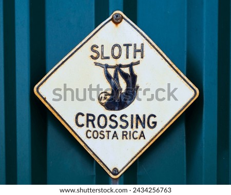 Funny Sloth Crossing sign on metal wall background, San Jose, Costa Rica