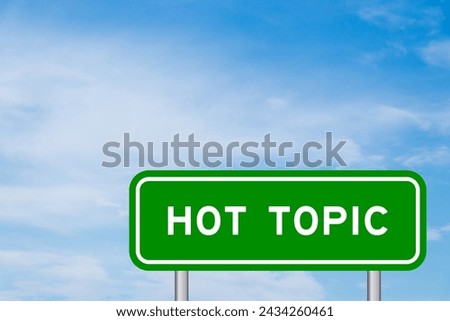 Green color transportation sign with word hot topic on blue sky with white cloud background