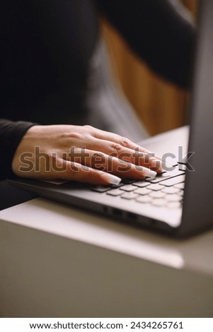 Close up photo of woman's hand typing on a laptop keyboard. Freelance and remote work. Modern female lifestyle