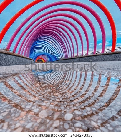 a semi circle that looks round because of the reflection of the water Royalty-Free Stock Photo #2434273353