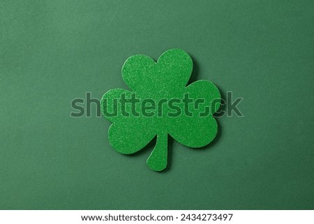 St. Patrick's day clover leaf isolated on green background. View from above. Festive creative concept.