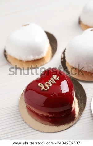 St. Valentine's Day. Delicious heart shaped cakes on white wooden table, closeup