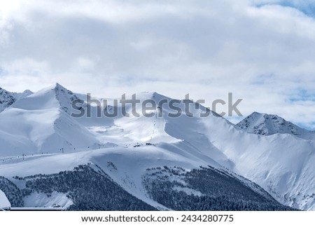 Picturesque winter landscape of the Arkhyz ski resort with mountains, snow, forest on sunny day. Caucasus Mountains, Russia.