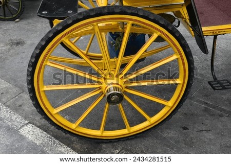 Carriage or andong wheels (a means of transportation drawn by horses) with a yellow frame.