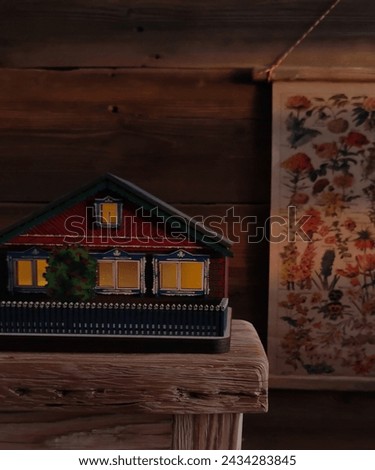 Cartoon house on table with flouer art painting