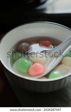 Tang Yuan is a Chinese dessert made of glutinous rice flour balls served in sweet soup. It's enjoyed during festivals like the Winter Solstice. Selective focus Royalty-Free Stock Photo #2434287447
