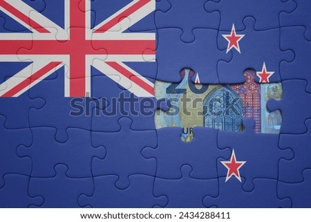 puzzle with the colourful national flag of new zealand and euro banknote. finance concept Royalty-Free Stock Photo #2434288411