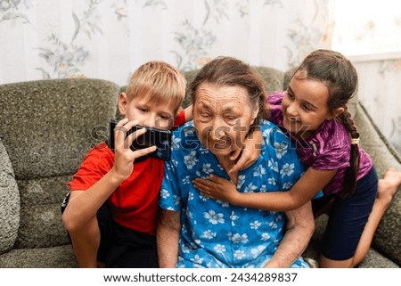 children and a very old great-grandmother Royalty-Free Stock Photo #2434289837