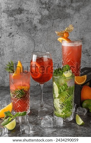 Various multicolored fruity cocktails. Beautiful colorful cocktails in the glasses.  lemonade, Mojito, cocktail with iced. Summer cocktail party. Cocktails drinks.  Royalty-Free Stock Photo #2434290059