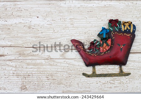 Christmas Background with a Santa Sleigh on Grunge Textured Wood Background  with copy space