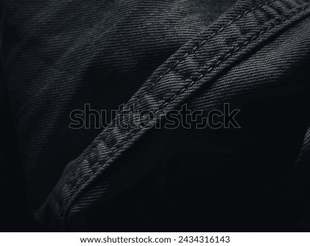 Dark jeans texture at night for a super cool fashion background.  Royalty-Free Stock Photo #2434316143