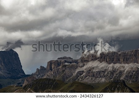 Panoramic view of Sella group with dramatic stormy sky and mist in Italian Dolomite from the Marmolada in South Tyrol, Italy.