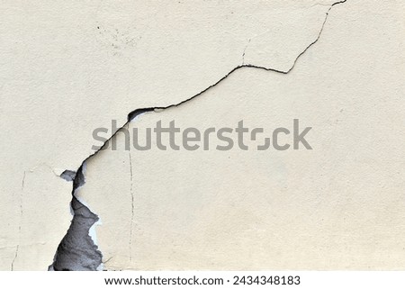 large long cracked yellow concrete floor or wall texture, building structures damaged by earthquake effect Royalty-Free Stock Photo #2434348183