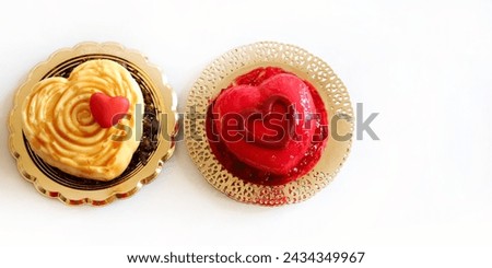Two heart - shaped Valentine's day dessert isolated on white background. Valentine's day celebration. Overhead view. Copy space. 
