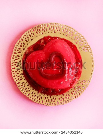 One heart - shaped Valentine's day dessert isolated on pastel pink background. Valentine's day celebration. Overhead view. Copy space. 