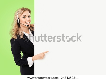 Call center. Customer support service phone operator, sales agent in headset, stand behind peep from signboard banner billboard board point show copy space ad text area, isolated green wall background