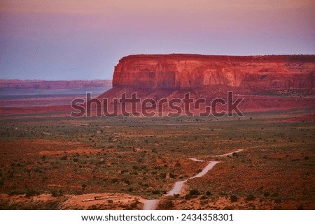Golden Hour Glow on Monument Valley Mesa with Winding Road