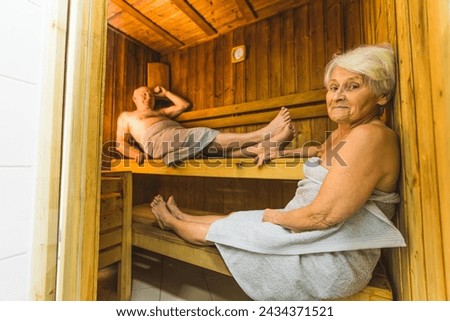 full shot of a senior Caucasian couple relaxing in the sauna on vacation. High quality photo