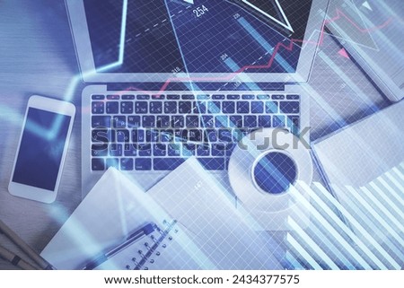 Stock market chart and top view computer on the table background. Double exposure. Concept of financial analysis.