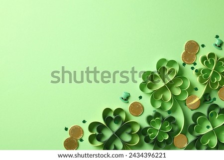 Four leaf clover craft, gold coins, confetti on green background. St. Patrick’s day concept.