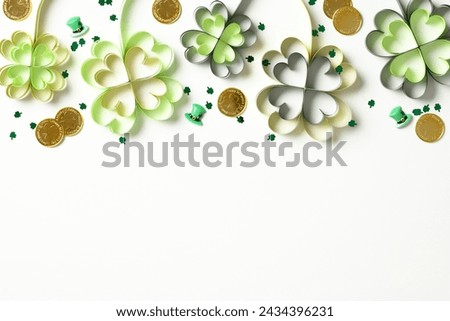 St Patrick's day top frame border of four leaf clover, gold coins, confetti on white background