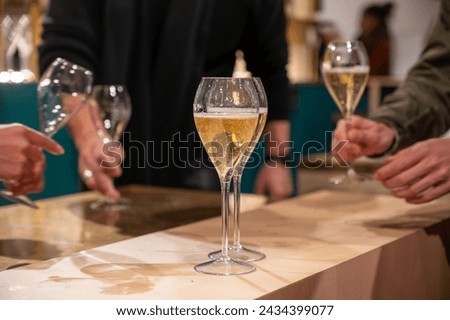 Pouring and tasting of dry sparkling wine champagne on winter weekend festival in December on Avenue de Champagne, Epernay, Champagne region, France Royalty-Free Stock Photo #2434399077