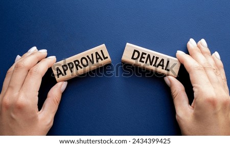 Approval or Denial symbol. Concept word Approval or Denial on wooden blocks. Businessman hand. Beautiful deep blue background. Business and Approval or Denial concept. Copy space Royalty-Free Stock Photo #2434399425
