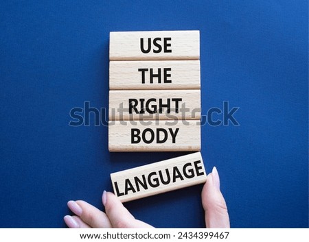 Use the right Body Language symbol. Concept words Use the right Body Language on wooden blocks. Businessman hand. Beautiful deep blue background. Business concept. Copy space