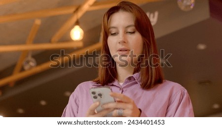Girl with phone. Woman Contemplating and Reflecting While Looking at Phone Screen. Introspection and emotional engagement experienced in digital communication. Modern relationships in the digital age.