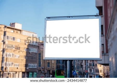 White billboard on the side of the road in the city center