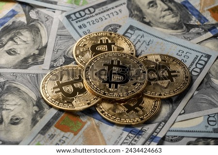 Close up of metal golden bitcoin crypto currency coins on US 100 dollar bills. Bitcoin coin and cash background Royalty-Free Stock Photo #2434424663