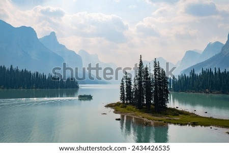 Beautiful Maligne Lake with Spirit Island and Boat in Jasper National Park, Alberta, Canada Royalty-Free Stock Photo #2434426535