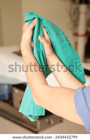 Surgeon having his hands surgically washed. A Caucasian doctor dressed in his right-hand profile with his hands full of foam and dressed in his surgical uniform.	 Royalty-Free Stock Photo #2434432799